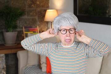 Mischievous senior woman at home 