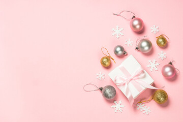 Christmas pink flat lay background with present box and decorations.