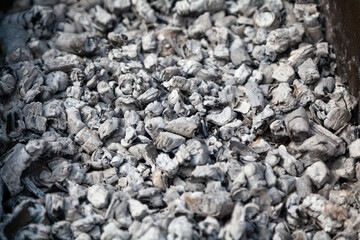 Hot white coals in grill close up