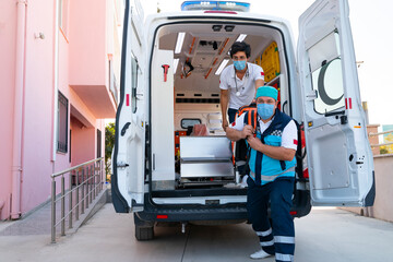 Emergency aid team preparing for emergency response to the patient in the ambulance