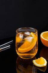 Aperol spritz cocktail in glass on the black background. Location vertical.