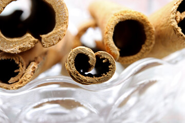close up of cinnamon sticks on wooden background