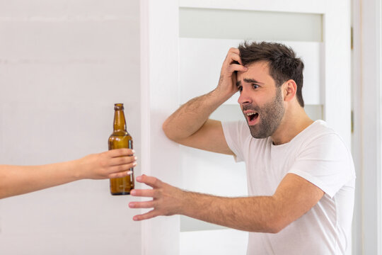Photo of man being excited about bottle of beer in the morning.