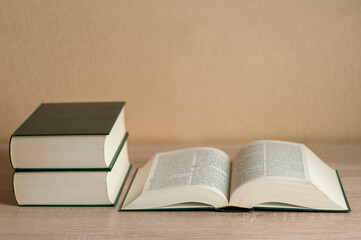 books in a pile on the table. neutral background