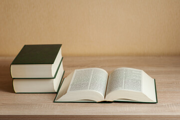 books in a pile on the table. neutral background