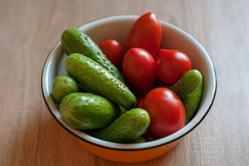 cucumbers and tomatoes in a cup on the table
