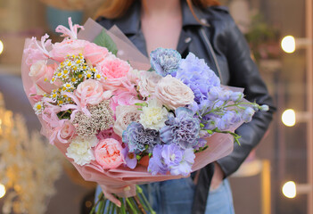 Fresh beautiful flower. Woman holding a big colorful flower bouquet. Work of florist