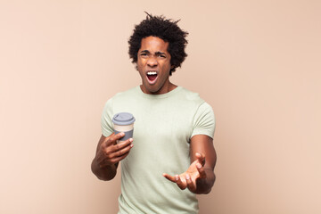 young black afro man looking angry, annoyed and frustrated screaming wtf or what’s wrong with you