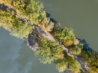 Aerial view of the lake in calm weather in the autumn at sunrise. View from air. Pond, orange grass, trees at dawn. Colorful aerial landscape at sunset in fall. Top view
Nature background concept