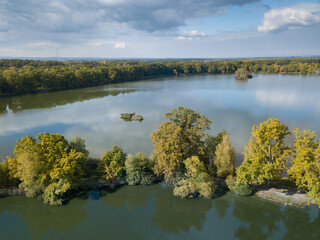 Aerial view of the lake in calm weather in the autumn at sunrise. View from air. Pond, orange grass, trees at dawn. Colorful aerial landscape at sunset in fall. Top view
Nature background concept