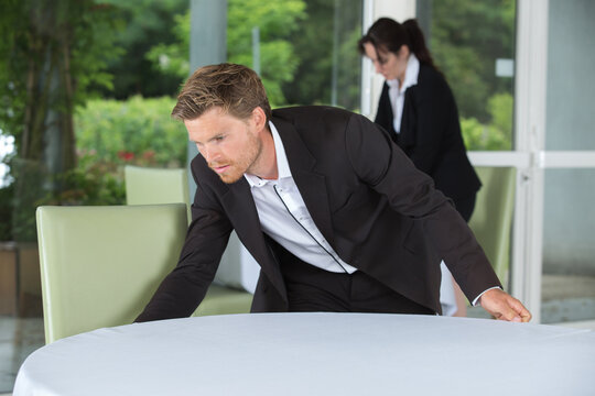 Waiter Setting The Table In A Fancy Restaurant