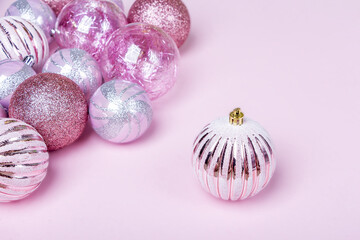 Christmas composition. Set of christmas pink decorations, shiny balls on pastel background. Mock up for new year gretting card. Close up