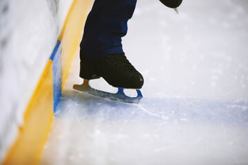Figure skates legs on ice. Figure skating school. Young figure skaters practicing at indoor skating...