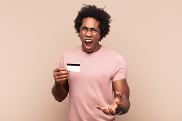 young black afro man looking angry, annoyed and frustrated screaming wtf or what’s wrong with you