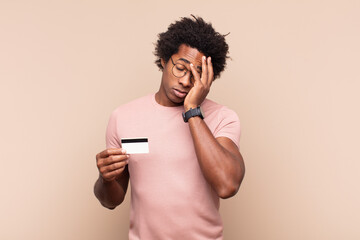 young black afro man feeling bored, frustrated and sleepy after a tiresome, dull and tedious task,...