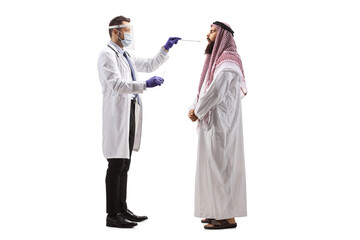Doctor with face shield taking a cotton swab test from an arab man `