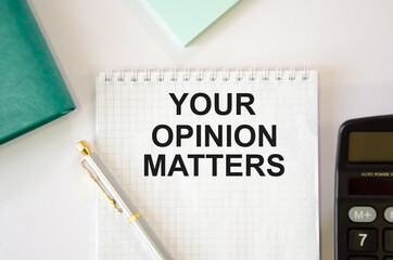  the text matters, your opinion is written on a white sheet of paper in a notebook with a calculator, stickers, pen