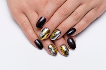 Gel nail design for Halloween. Black, shimmery, brown, silver, gold manicure on short oval nails...
