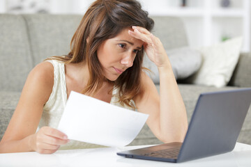 woman sitting in front of laptop on sofa