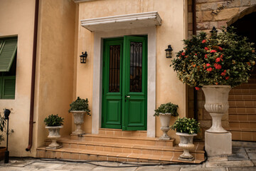 Fototapeta na wymiar White wall, wooden door and window. Traditional european architecture