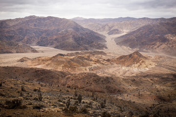Fototapeta na wymiar Horizontal panoramic view of the desert landscape at Pan de Azucar (Sugar Bread) natural reserve, in Chile’s Atacama Region. This desert is considered the driest and most inhospitable place on Earth