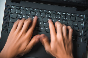 photo of a person typing on a keyboard