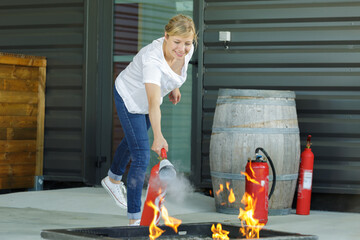 woman learning to use the fire extinguisher