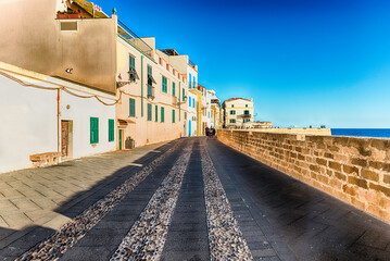 Walking on the historic ramparts in Alghero, Sardinia, Italy