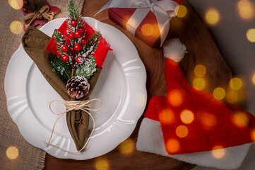 .Table set for Christmas on rustic wooden background with bokeh lights. Top view, Copy space