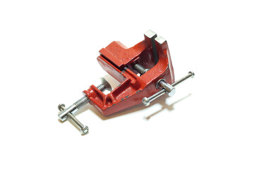 small red vise on white background close up