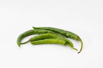 Isolated group of green chili peppers on white background