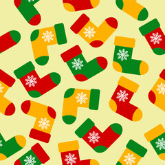 Colorful christmas socks with snowflackes on light yellow background. Red, green and yellow socks. Seamless pattern, vector graphics. Print for wrapping paper, fabric, background. ornament.