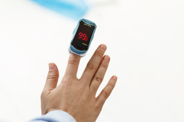Pulse Oximeter on finger, measuring blood oxygen level, detecting coronavirus pneumonia
