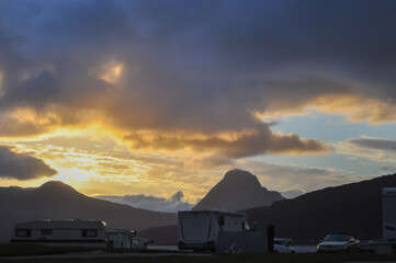 View to the sunset over Nesna peninsula and Tomma island from Nesna village. Campers in the foreground.