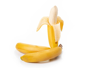 Shooting in the studio. A branch of ripe yellow bananas in a peel. On white background. Close-up.