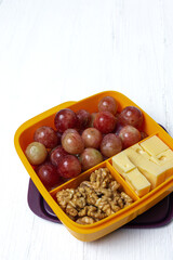 Food in Plastic containers ready to eat with Cheese, grapes and nuts