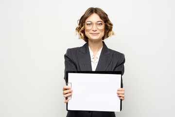 Fototapeta premium Business woman with a folder of documents on a light background cropped view and shirt suit