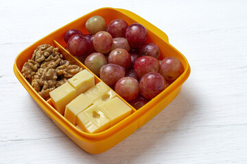 Food in Plastic containers ready to eat with Cheese, grapes and nuts