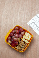 Food in Plastic containers ready to eat with Cheese, grapes and nuts