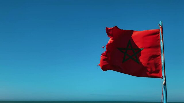 The national flag of Morocco flutters in the wind