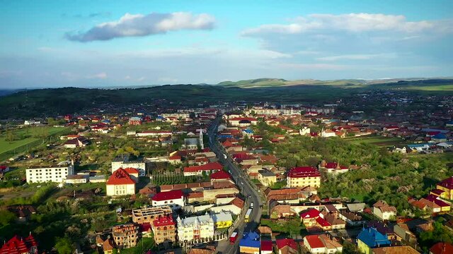 Huedin,Cluj/Romania-04.30.2020-Aerial view over Huedin city centre. You can see the city hall, house of culture, Public finances administration, Vladeasa hotel, Reformed Church and DN1E60 road