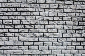Texture of a stone grey wall. Part of a building wall. Close-up.