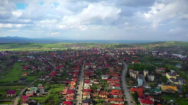 Huedin,Cluj/Romania-04.30.2020-Aerial view over Huedin city centre. You can see the city hall, house of culture, Public finances administration, Vladeasa hotel, Reformed Church and DN1E60 road
