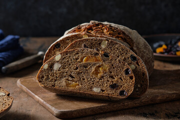 Slices of rye bread with hazelnuts and dried fruit like apricots, raisins and plums.