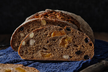 Slices of rye bread with hazelnuts and dried fruit like apricots, raisins and plums.