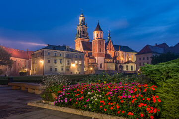 Wawel castle and Wawel cathedral seen from colorful garden in the night, Krakow, Poland
