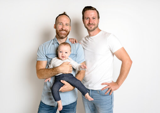 Gay Or Homosexual Male Couple With Their Daughter Baby Over White Background