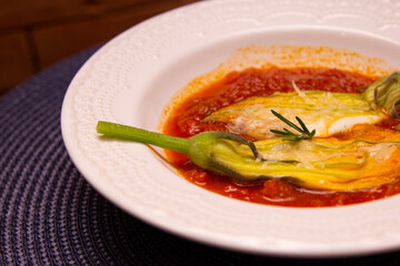 Gourmet food, pumpkin stuffed with buffalo mozzarella and fresh tomato sauce