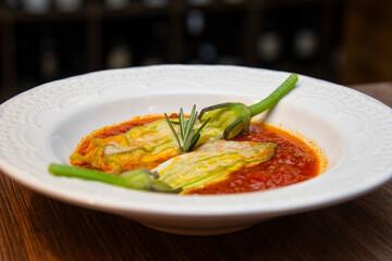 Gourmet food, pumpkin stuffed with buffalo mozzarella and fresh tomato sauce