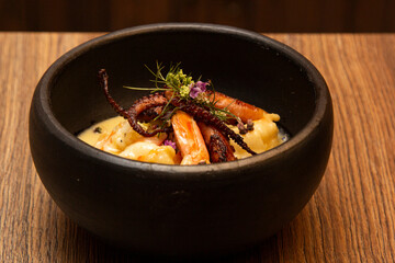 Shrimp and Octopus Casserole with Honey and Flowers Sauce.